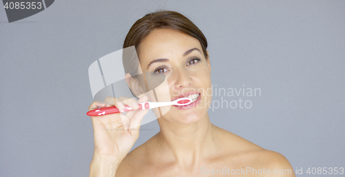 Image of Healthy young woman cleaning her teeth