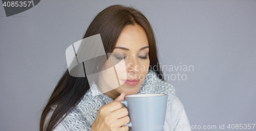 Image of Beautiful brunette woman with a cup of hot drink