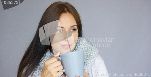 Image of Beautiful brunette woman with a cup of hot drink