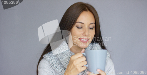Image of Beautiful brunette woman with a cup of hot drink