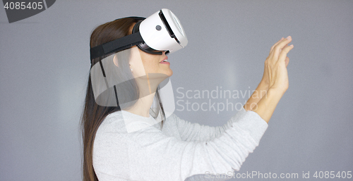 Image of Adorable woman working with virtual reality glasses