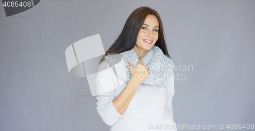 Image of Elegant middle aged woman posing with woolen warm scarf