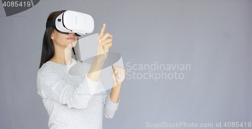 Image of Adorable woman working with virtual reality glasses