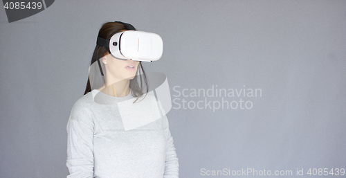 Image of Excited woman watching something on her virtual reality helmet