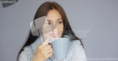 Image of Beautiful brunette woman with a cup of hot drink