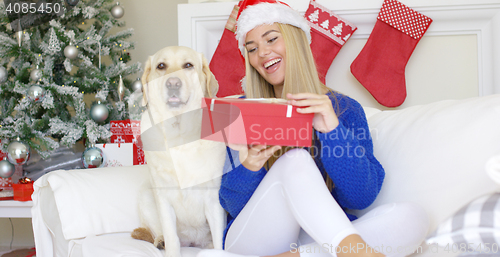 Image of Beautiful sexy girl sitting at christmas time on sofa