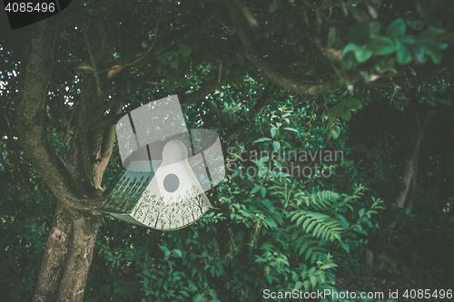 Image of Birdhouse with decorative tree patterns