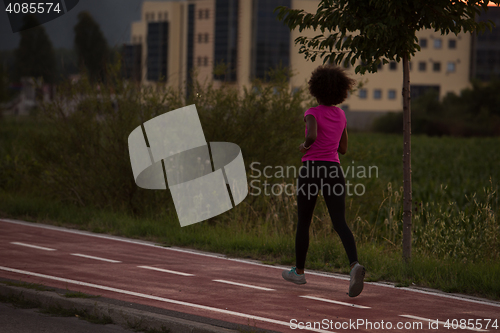Image of a young African American woman jogging outdoors