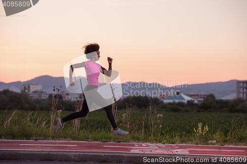 Image of a young African American woman jogging outdoors