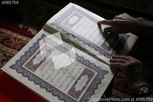 Image of Muslim man reading the Koran in the Aladza painted mosque,Tetovo, Macedonia