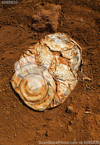 Image of Old crushed rusty tin can