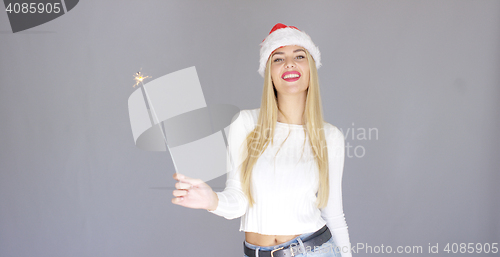 Image of Pretty blond girl enjoy chrismas with sparkler