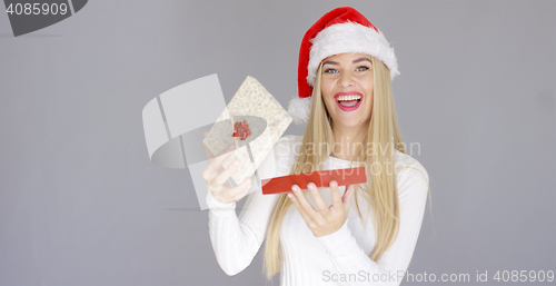 Image of Beautiful girl smiling just after open christmas gift