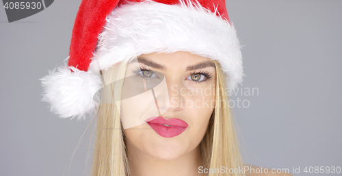 Image of Close up portrait of beautiful blond girl in Santa Claus Hat