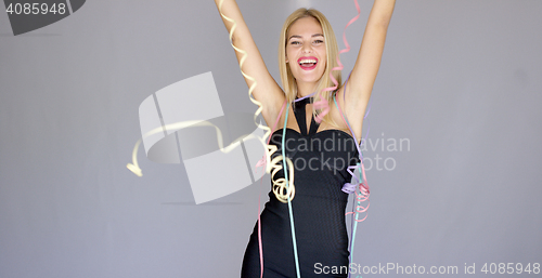 Image of Happy and sexy young woman in evening dress dancing