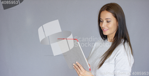 Image of Beautiful middle aged woman using tablet computer