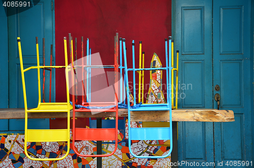 Image of Colorful chairs on a wooden table