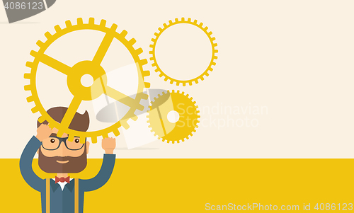 Image of Businessman holding up gears