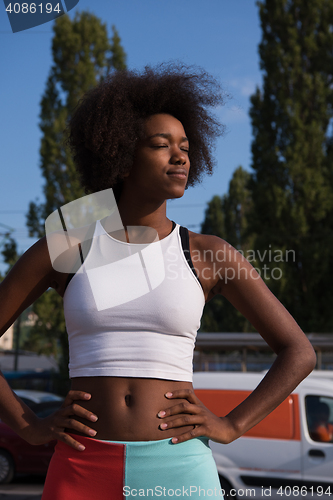 Image of Portrait of sporty young african american woman running outdoors