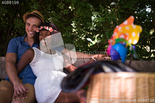 Image of Young multiethnic couple having a bike ride in nature