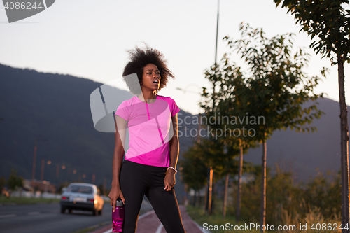 Image of Portrait of a young african american woman running outdoors