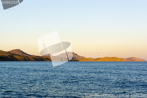 Image of Mountainous coast at sunset light