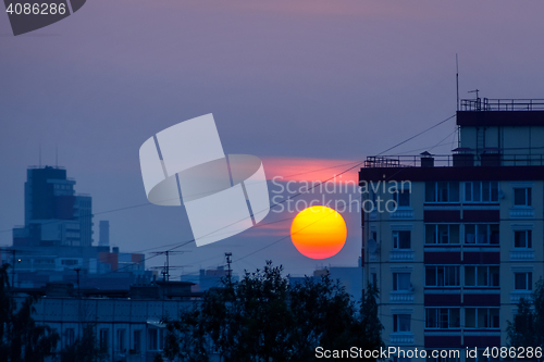 Image of Vivid sun at sunset in city