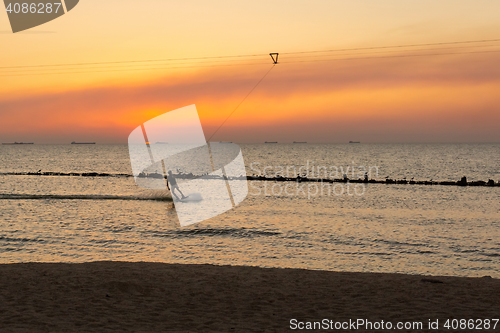 Image of Man on board glides over the wave