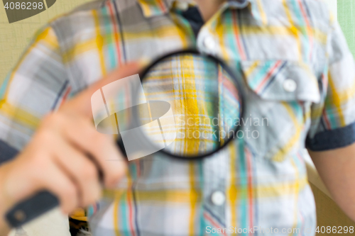 Image of Lad with magnifying glass close