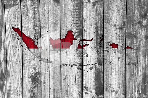 Image of Map and flag of Indonesia on weathered wood