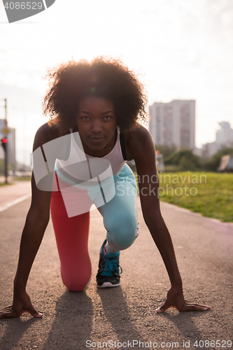 Image of Portrait of sporty young african american woman running outdoors