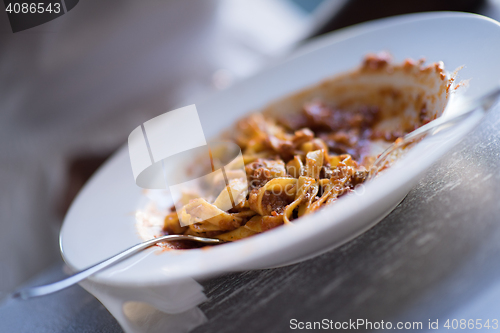 Image of a young African American woman eating pasta