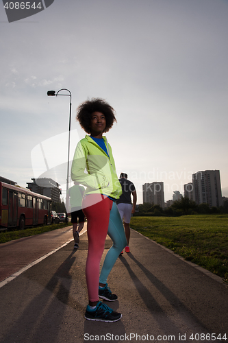 Image of Portrait of sporty young african american woman running outdoors