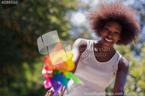 Image of pretty young african american woman riding a bike in forest