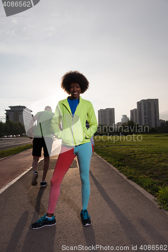 Image of Portrait of sporty young african american woman running outdoors