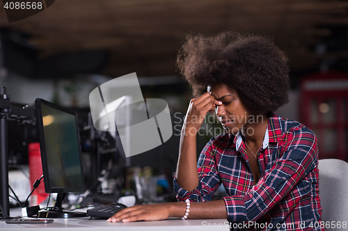Image of a young African American woman feels tired in the modern office