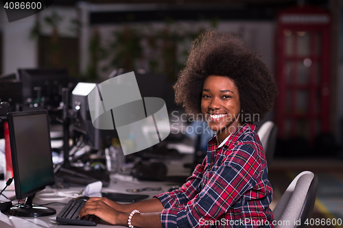 Image of portrait of a young African American woman in modern office