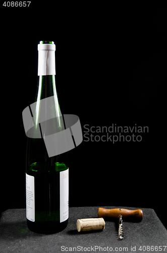 Image of Uncorked wine bottle with utensiles