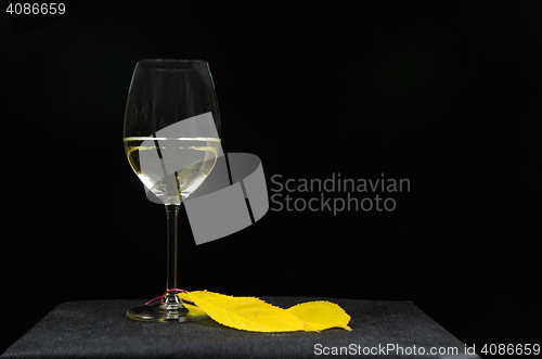 Image of Glass of white wine at black background