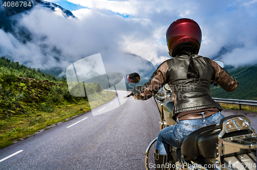 Image of Biker girl First-person view, mountain serpentine.