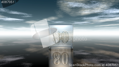 Image of number eighty in glass cube under cloudy sky - 3d rendering