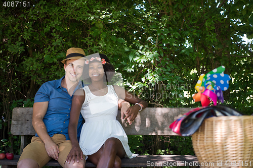 Image of Young multiethnic couple having a bike ride in nature