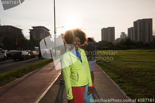 Image of Portrait of sporty young african american woman running outdoors