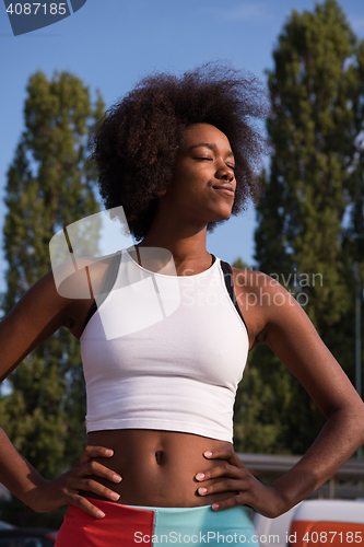 Image of Portrait of sporty young african american woman running outdoors