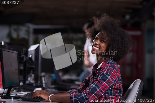 Image of portrait of a young African American woman in modern office