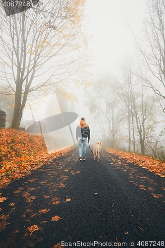 Image of Man with dog in autumn nature