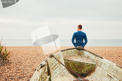 Image of Alone and pensive man on the beach