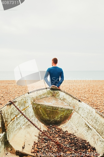 Image of Alone and pensive man on the beach