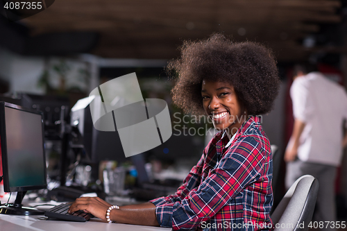 Image of portrait of a young African American woman in modern office