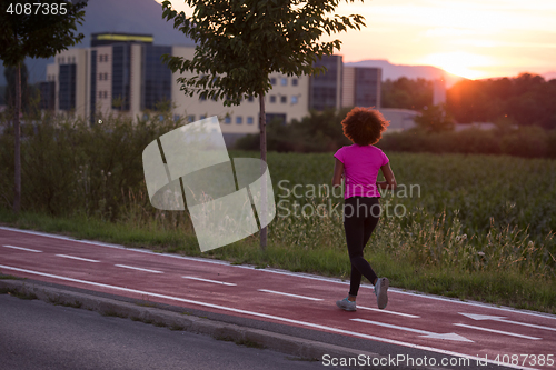 Image of a young African American woman jogging outdoors